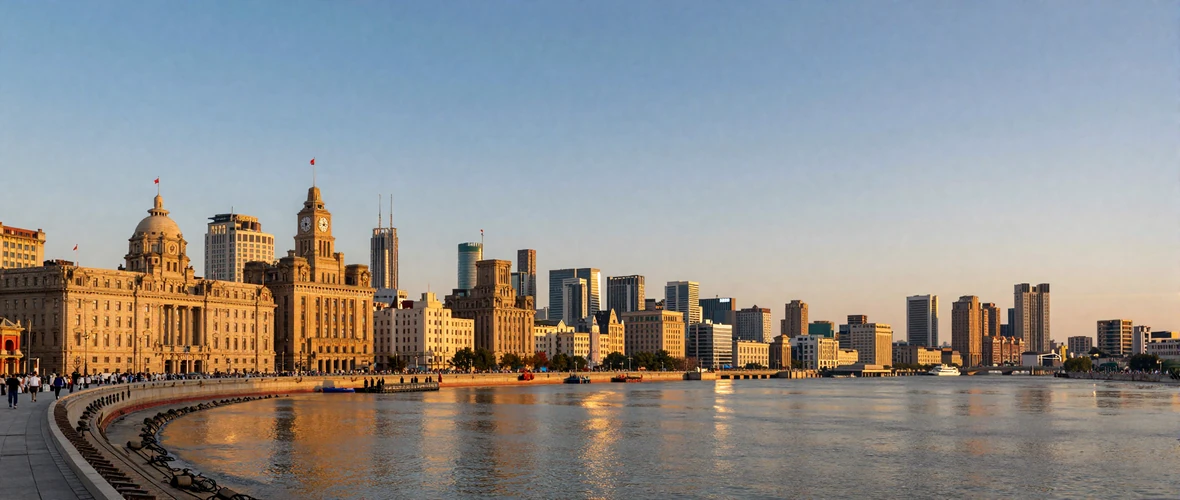 Shanghai Bund waterfront at golden hour with Pudong skyline across the Huangpu River