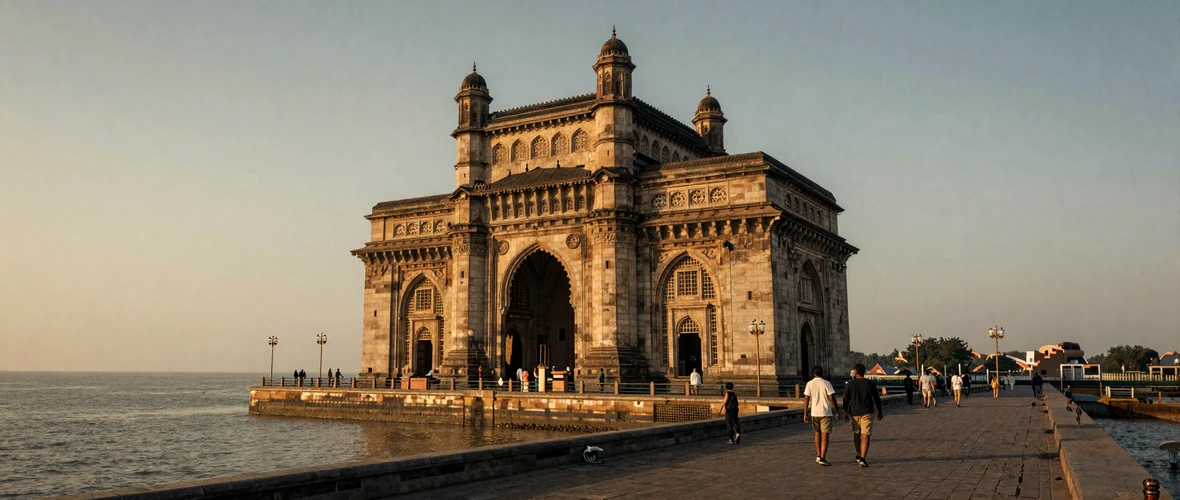 Gateway of India monument in Mumbai at golden hour with couples walking along the waterfront