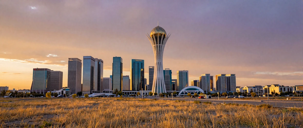 Modern Astana skyline with Bayterek Tower and futuristic architecture against the vast Kazakh steppe at sunset